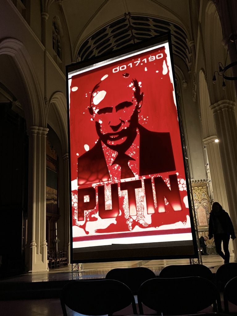 Andrei Molodkin, <i>Putin Filled with Ukrainian Blood</i>(2022), projected at a church in central London. Courtesy of the artist.
