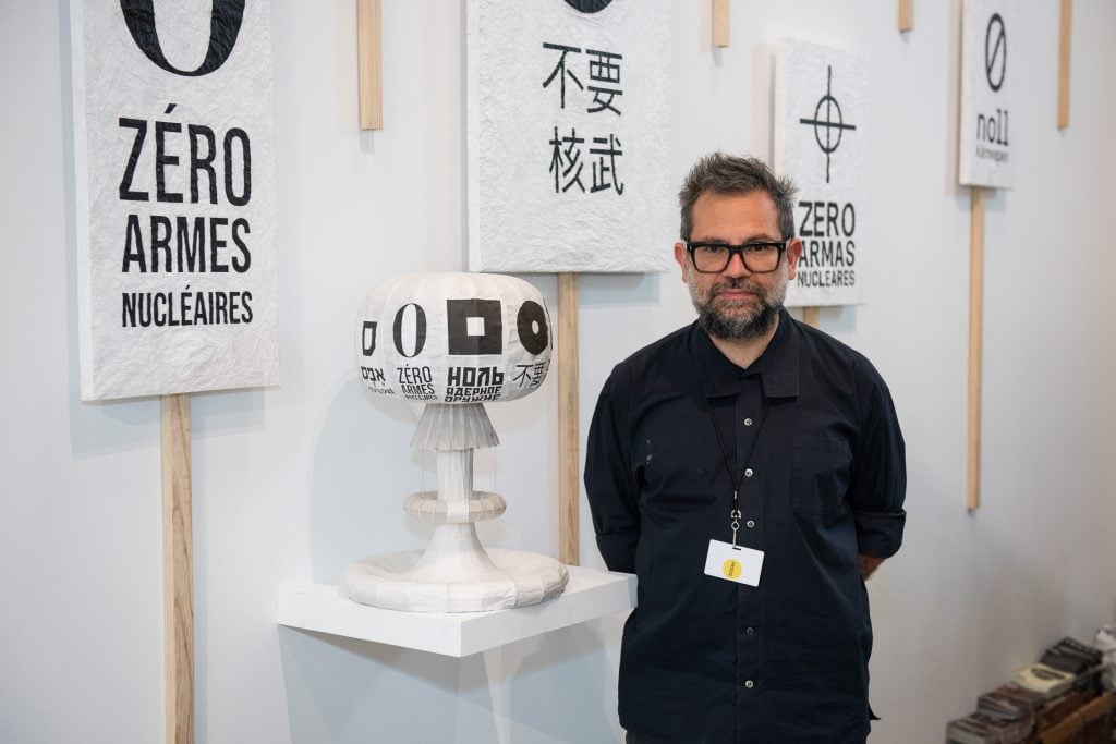 Artist Pedro Reyes in front of his ZERO NUKES installation at Frieze New York 2022.