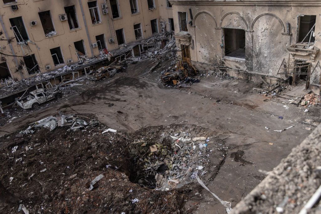 KHARKIV, UKRAINE - MARCH 28: A rocket crater is seen in the courtyard of the destroyed Kharkiv Regional State Administration building on March 28, 2022 in Kharkiv, Ukraine. More than half Kharkiv's 1.4 million people have fled the city since Russia's invasion on Feb. 24, which was followed by weeks of intense bombardment. Russian forces remain to the city's north and east, but have met heavy resistance from Ukrainian troops here. (Photo by Chris McGrath/Getty Images)