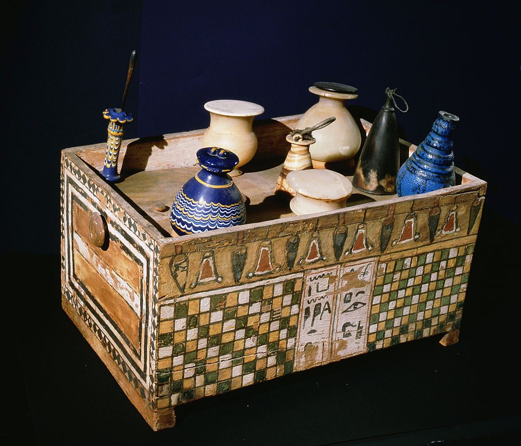 Decorated box of flasks and jars holding fragrances and cosmetics from the tomb of Merit, wife of royal architect Kha, Egypt. Photo by Werner Forman/Universal Images Group/Getty Images.
