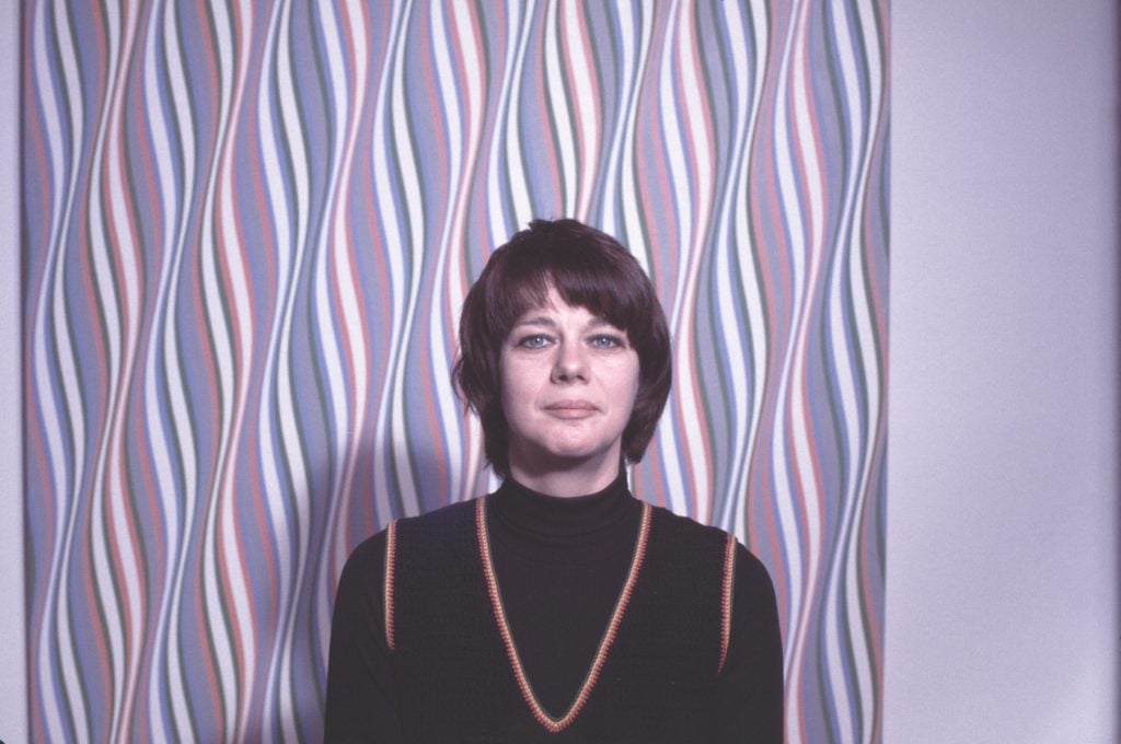 Portrait of British Op artist Bridget Riley with some of her work, 1975. Photograph by Jack Mitchell/Getty Images.