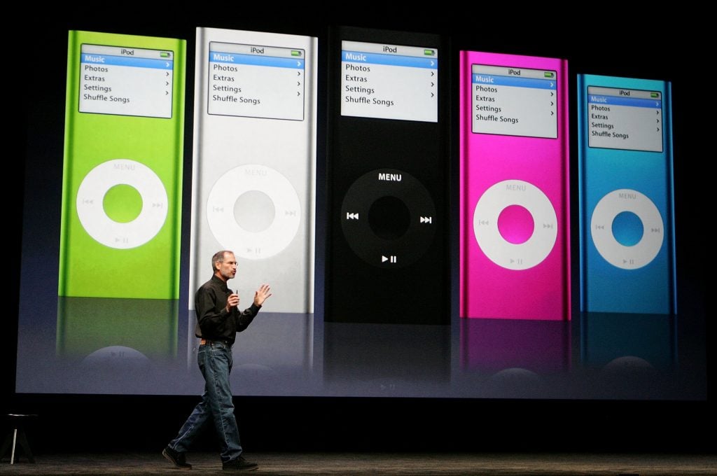 Apple CEO Steve Jobs delivering a keynote address in front of an image of the newly announced iPod Nano during an Apple media event in 2006. (Photo by Justin Sullivan/Getty Images)