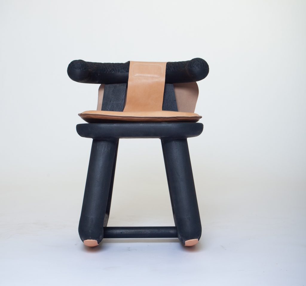 Solid basswood "Africana Chair" with leather seat by Yohance Lacour, designed by EDL awardee Norman Teague and produced by Norman Teague Design Studios. Courtesy of Norman Teague.