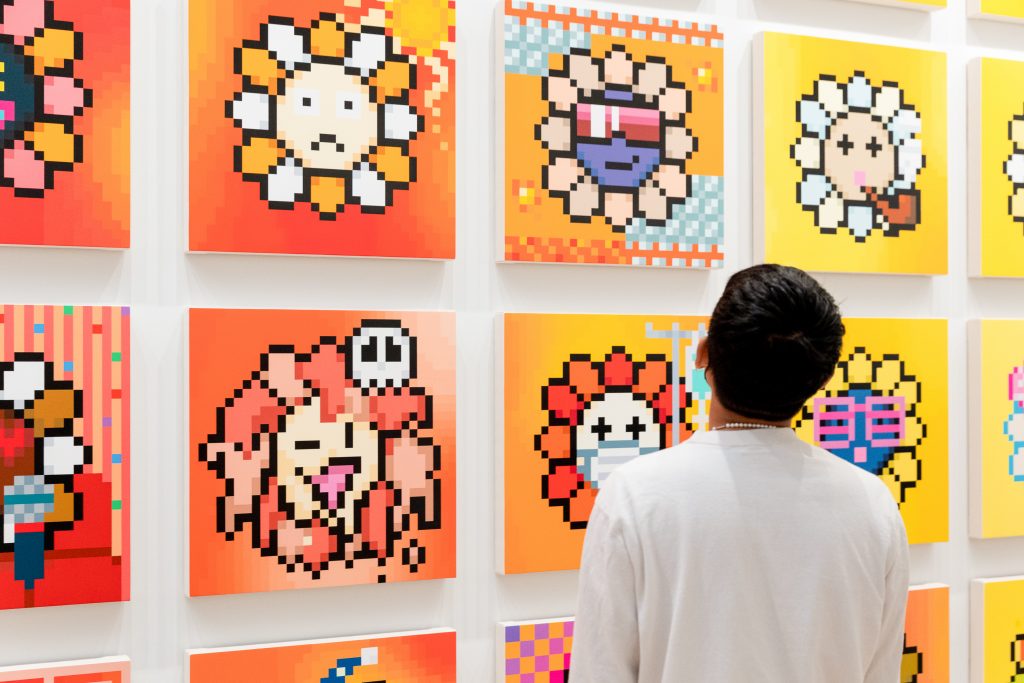 A gallery-goer looks on at the opening of Takashi Murakami's "An Arrow Through History." Courtesy of the artist and Gagosian. Photo: Yvonne Tnt.