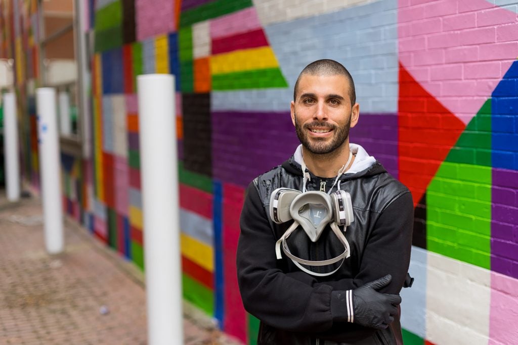 Typoe with his alley mural installation, <em>Over The Rainbow</em> in the future Pop District. Photo courtesy of the Andy Warhol Museum, Pittsburgh. 