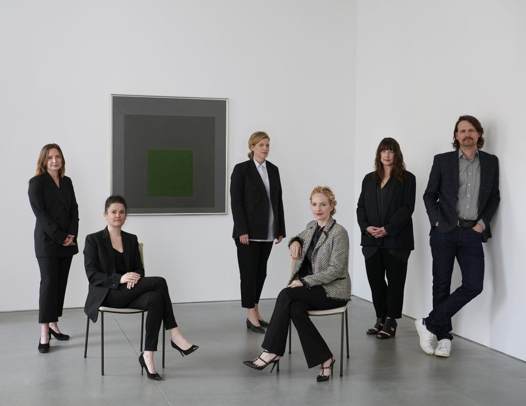 David Zwirner's Secondary Market Department (L to R): Katherine Lukacher, Meghan Hill, Alexandra Whitney, Kristine Bell, Kelly Reynolds, Cy Amundson. In the background is Josef Albers's Homage to the Square: Embedded (1963). © The Josef and Anni Albers Foundation / Artists Rights Society (ARS), New York. Courtesy of the Josef and Anni Albers Foundation and David Zwirner.  Photo: Jason Schmidt.