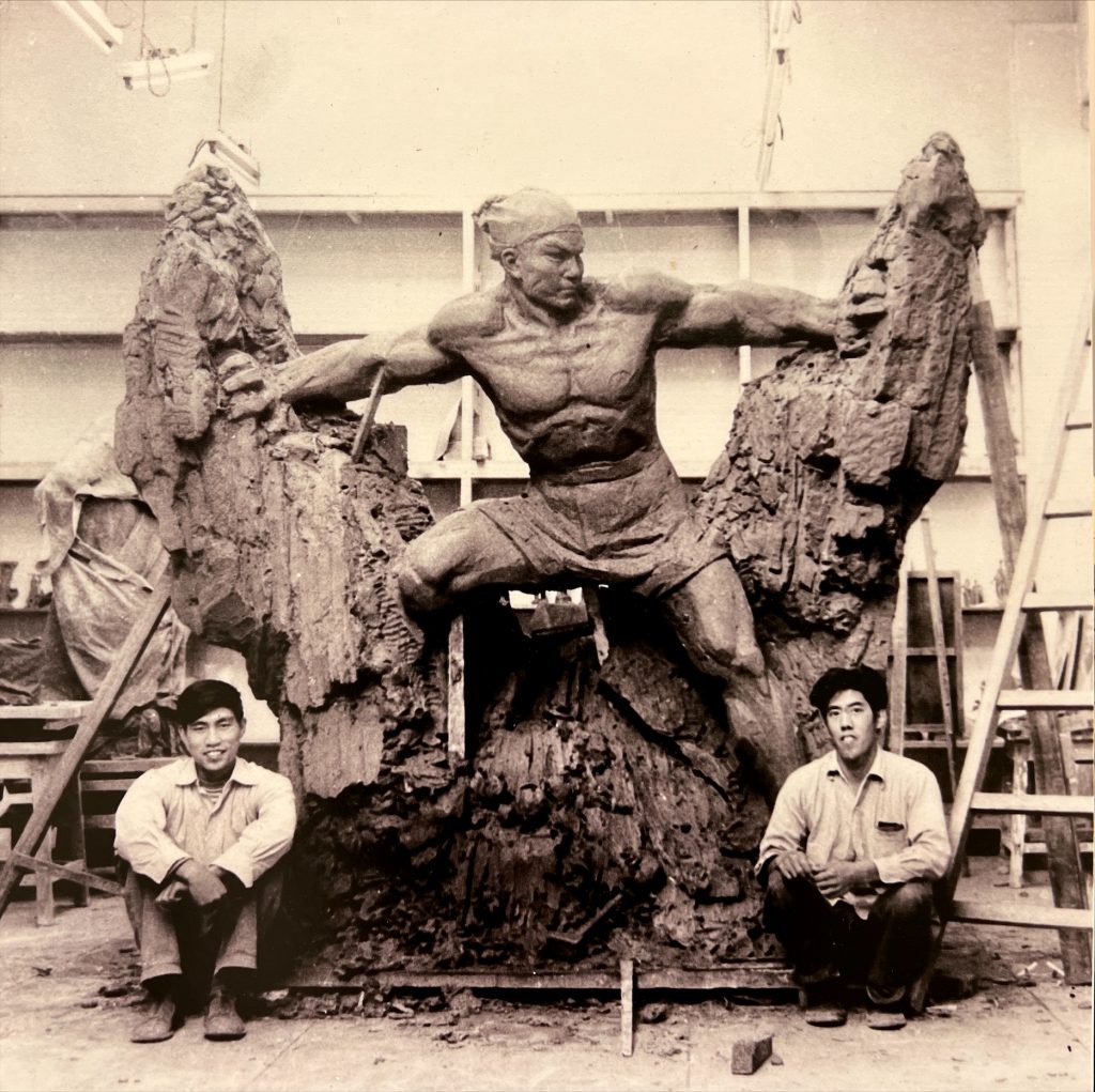 Liu Shiming, right with the clay maquette for Cutting Through Mountains to Bring in Water” (1958). Photo courtesy of the Godwin-Ternbach Museum.