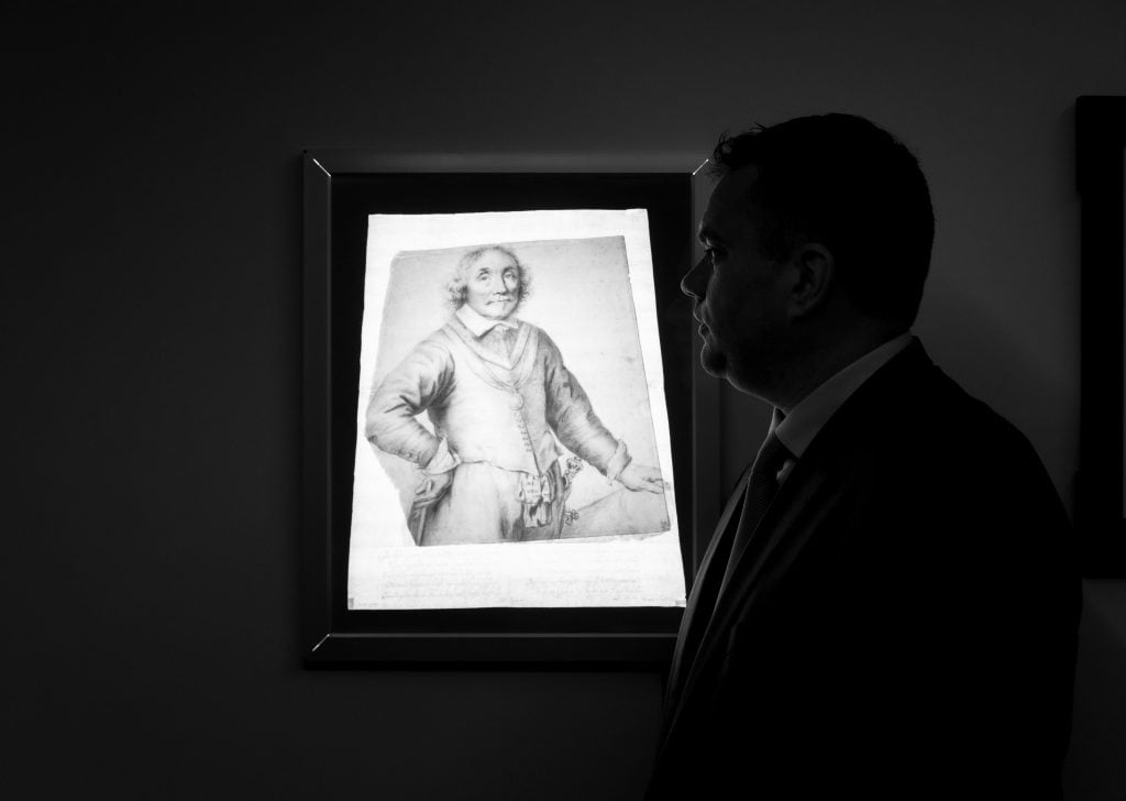 Christopher Bishop with Jan Lievens's Portrait of Admiral Maarten Harpertszoon Tromp (1597–1653), ca. 1652/53, overlaid with the famous print based on the drawing. Photo courtesy of Christopher Bishop Fine Art, New York.
