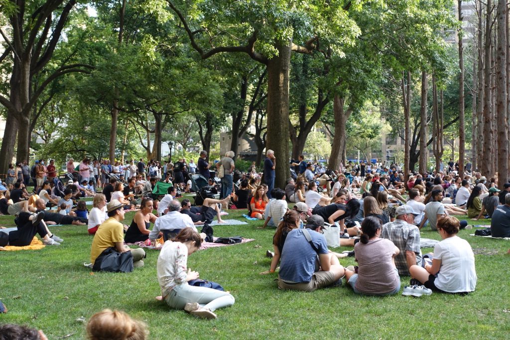 Parkgoers taking in a musical performance on Madison Square Park's Oval Lawn as part of the Carnegie Hall Citywide concert series in 2021. Image courtesy Madison Square Park Conservancy