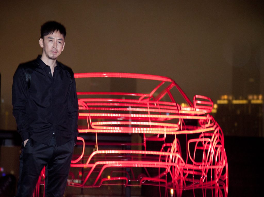 SHANGHAI, CHINA - MAY 21:Yuxing Huang of China for a picture with Range Rover Evoque wireframe at outside the Waterhouse on May 21, 2011 in Shanghai, China. (Photo by Kevin Lee/Getty Images for Range Rover Evoque)