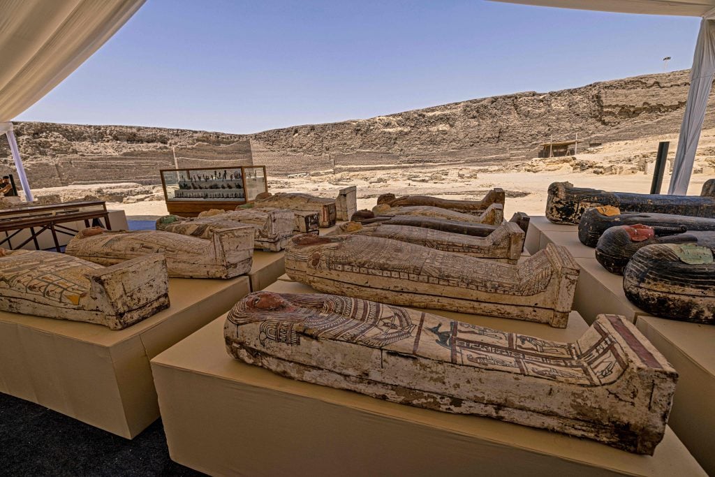 Sarcophaguses found in a cache at the Saqqara necropolis, southwest of Egypt's capital. Photo by Khaled Desouki/AFP via Getty Images.
