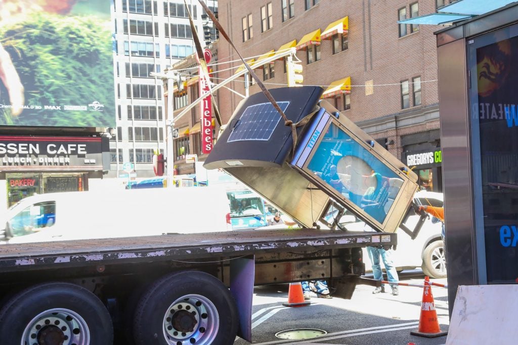 The removal of the last payphone kiosk in New York City. Photo courtesy of LinkNYC. 