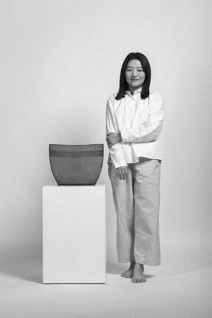 Artist Dahye Jeong with her prize-winning work. Courtesy of Loewe.