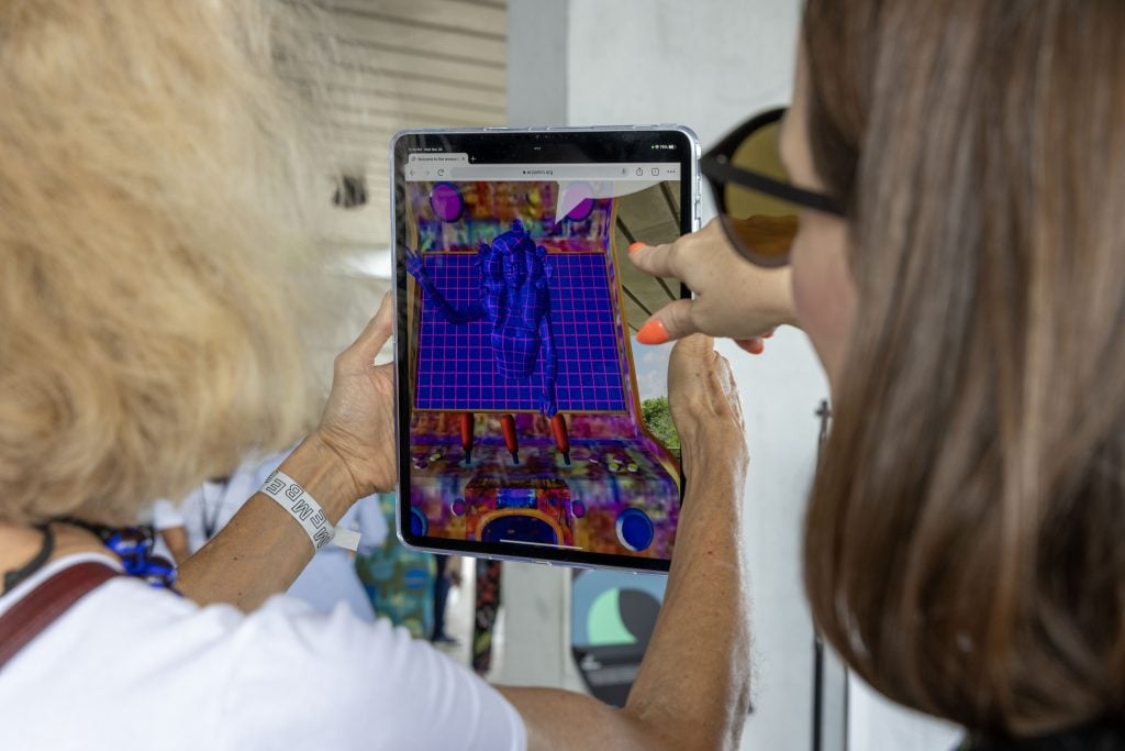Users engage with artist Carla Gannis's augmented-reality work \Welcome to the wwwunderkammer (2022), the first of PAMM's New Realities commissions. Photo: Lazaro Llanes. Courtesy Pérez Art Museum Miami.