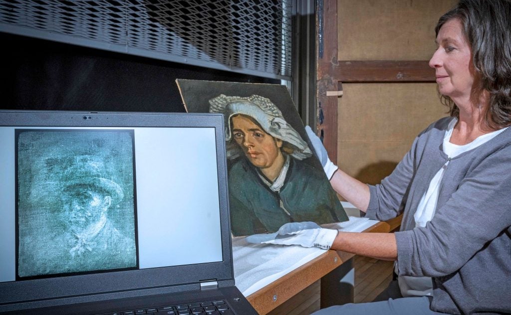 National Galleries of Scotland conservator Lesley Stevenson with Head of a Peasant Woman and an X-ray image of the hidden self-portrait. Photo: Neil Hanna.
