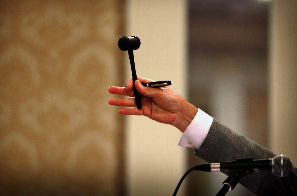An auctioneer's gavel raised dramatically. (Photo by Julien Behal/PA Images via Getty Images)