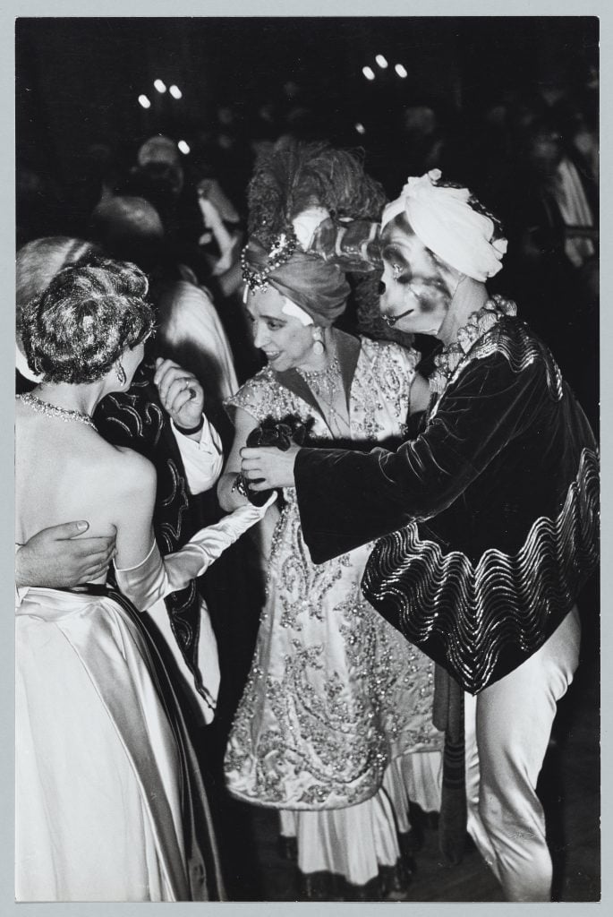 Schiaparelli at a masquerade ball in 1952;  the man is wearing a jacket she designed.  © Elsa Schiaparelli SAS.  © Rights reserved, Paris, Palais Galliera - Fashion Museum.  © Paris Museums, Palais Galliera, Dist.  RMN- Grand Palais / picture of the city of Paris.