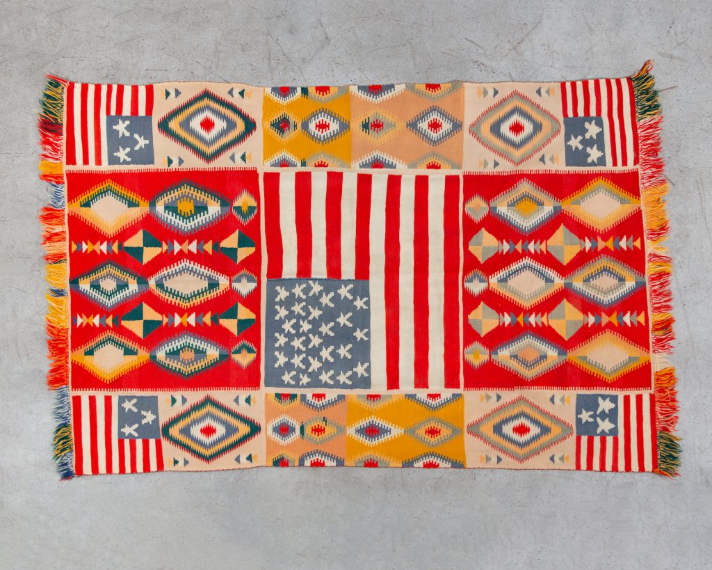 Unknown artist, A Unique Example of a Transitional-phase Navajo Weaving in the "Germantown" Tradition, with American Flag Panels and Eye-dazzlers