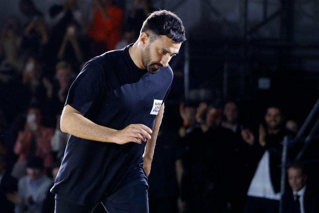 Burberry's Chief Creative Officer Riccardo Tisci acknowledges the applause after a Burberry show. (Photo by Tolga AKMEN / AFP) (TOLGA AKMEN/AFP via Getty Images)