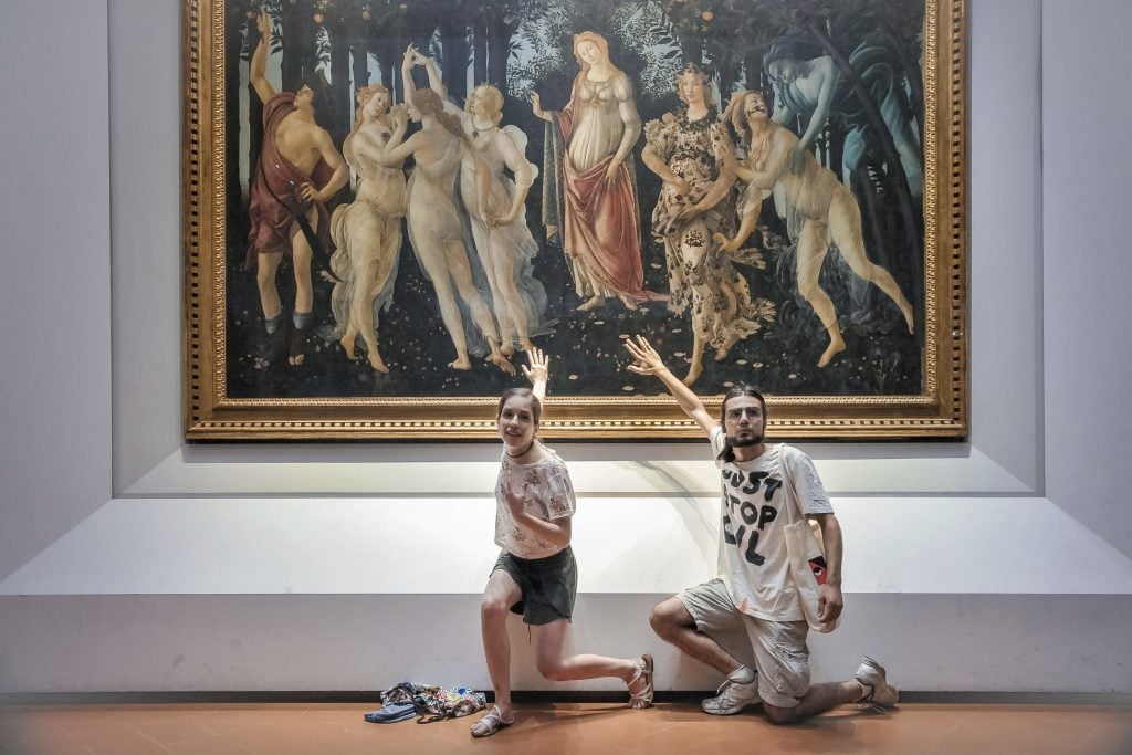 Protesters from the action group Ultima Generazione glue their hands to the glass covering Sandro Botticelli's Primavera at Uffizi in Florence, Italy. Photo by Laura Lezza/Getty Images.