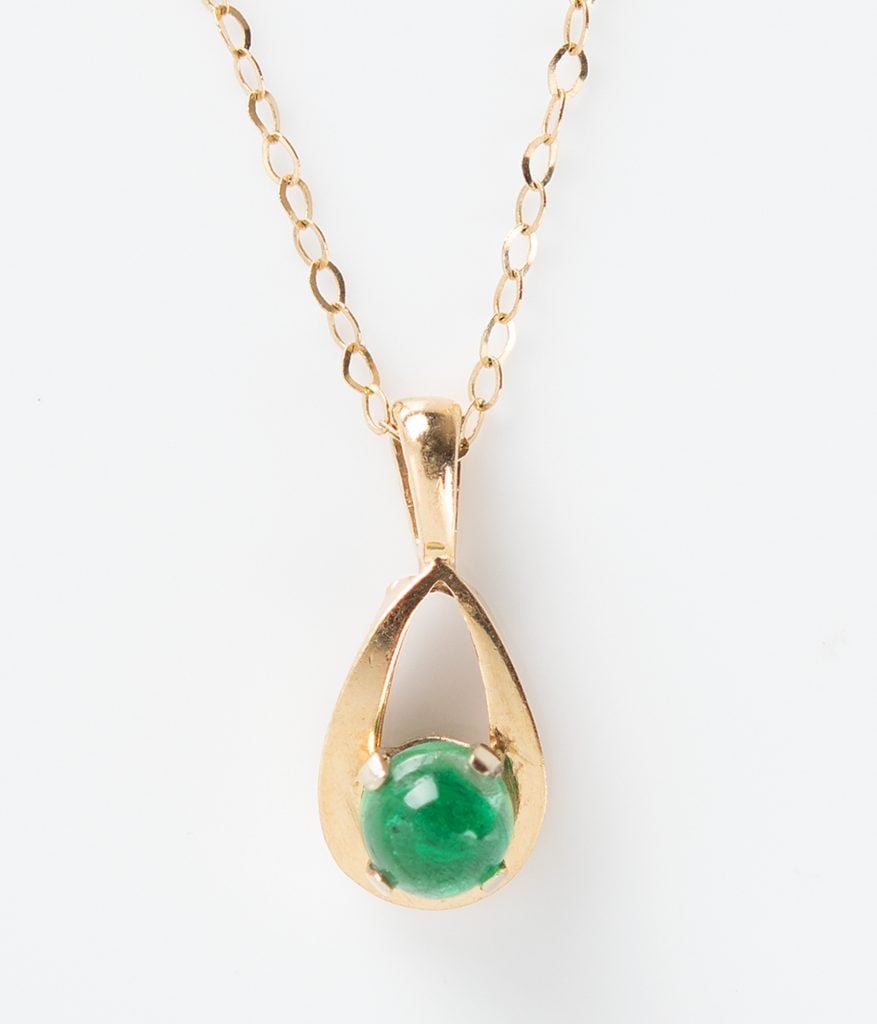 A 14-karat gold necklace with an emerald given by Elon Musk to his college girlfriend, Jennifer Gwynne. Photo courtesy of RR Auction, Boston.