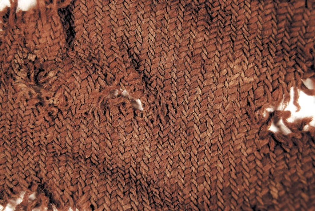 Legal cloth known as <em>vaðmál</em> from late 17th-century archaeological deposits at the site of Gilsbakki in western Iceland. Gilsbakki was the seat of Viking Age and medieval chieftains from around 900 to 1210. Photo by Sarah Philbrick Kelly, 2008.