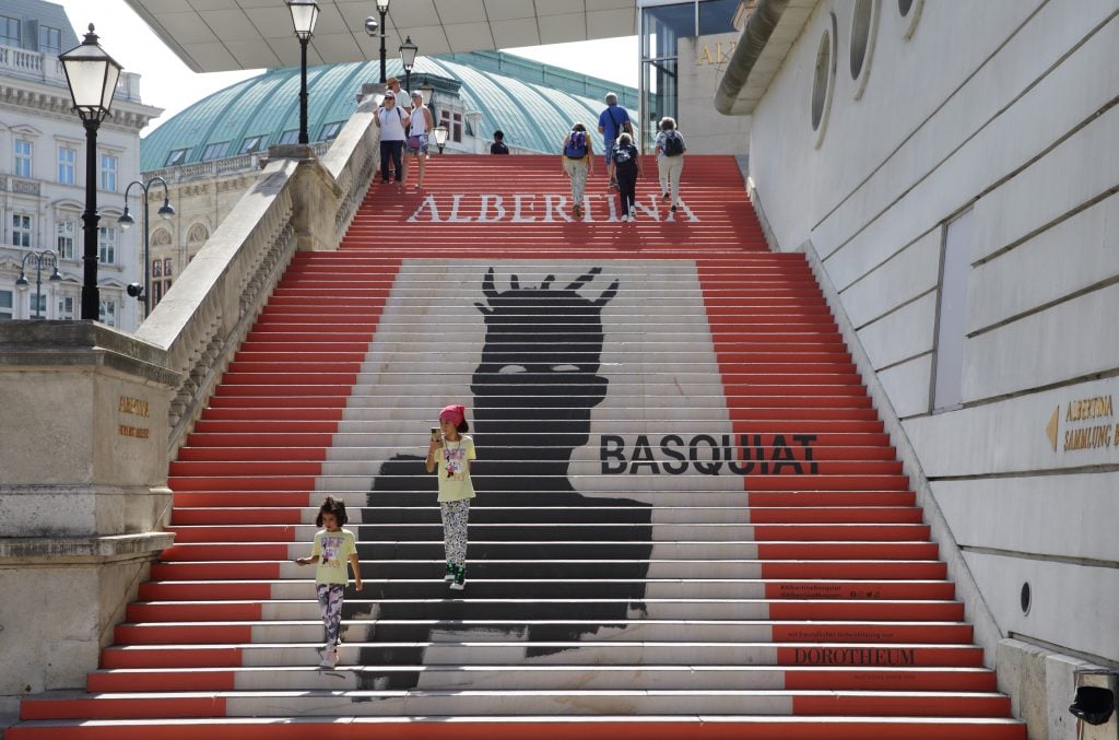 VIENNA, AUSTRIA - SEPTEMBER 08: Stairs leading up to the entrance of Albertina museum advertise the "Basquiat. Die Retrospektive" exhibition at Albertina on September 8, 2022 in Vienna, Austria. (Photo by Heinz-Peter Bader/Getty Images)