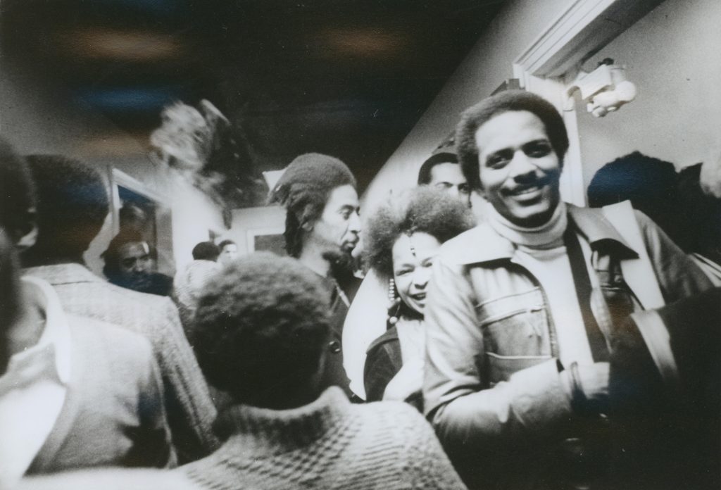 Barbara Mitchell (center right) and Tyrone Mitchell (far right) at the opening of the exhibition Synthesis, November 18, 1974. Photograph by Camille Billops. Courtesy the Hatch-Billops Collection, New York