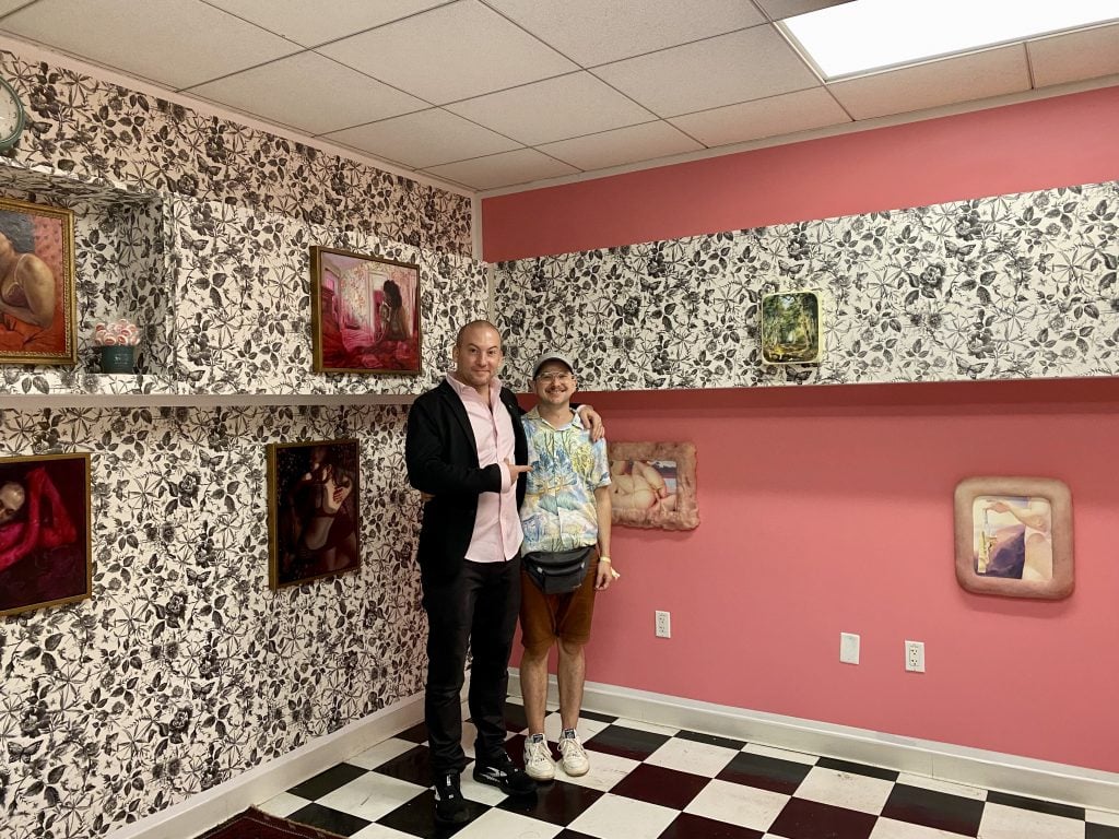 Curator Jason Patrick Voegele and artist Cobi Moules with their presentation "Love Junk," also featuring Edie Nadelhaft and Michelle Doll, at New York's SPRING/BREAK Art Show 2022. Photo by Sarah Cascone. 
