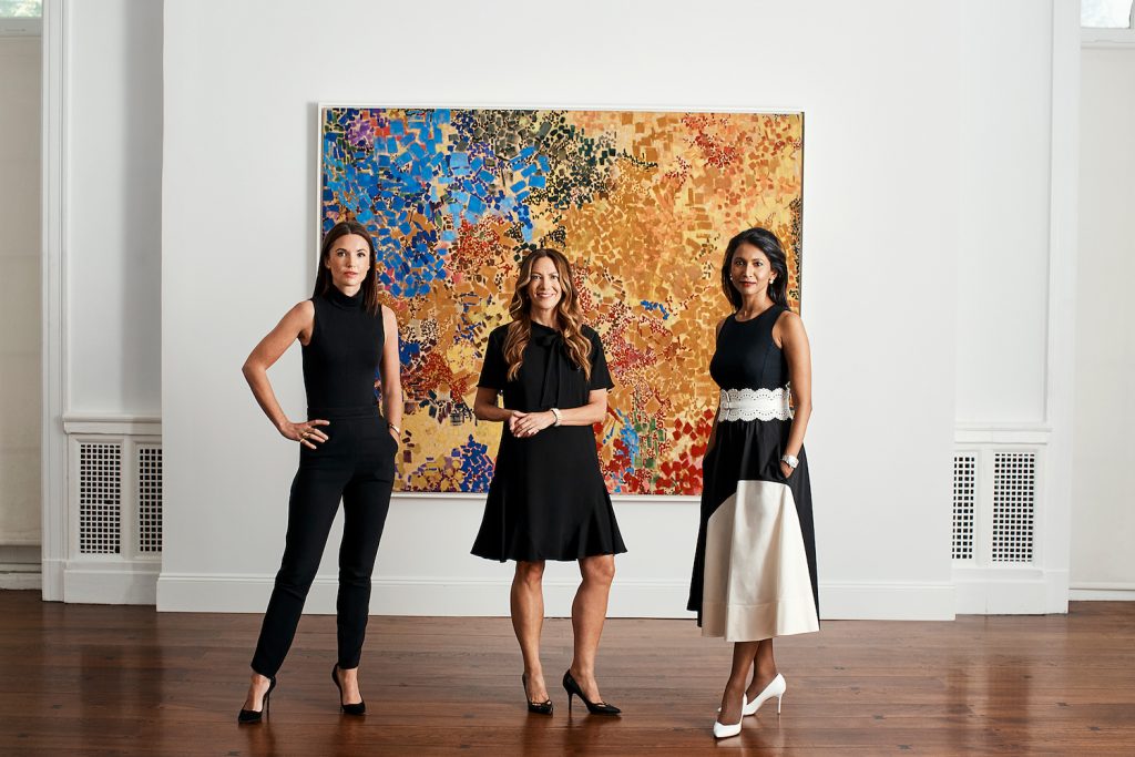 (L to R) Christine Berry, Martha Campbell and Sukanya Rajaratnam in front of a painting by Lynne Drexler. Photographed by Weston Wells. Image courtesy Berry Campbell and Mnuchin.