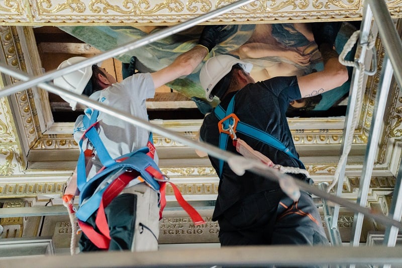 Art handlers remove Artemisia Gentileschi, Allegory of the Inclination (1816) from the ceiling of the Casa Buonarroti, Florence.  Photo by Olga Makarova, courtesy of Casa Buonarroti, Florence.