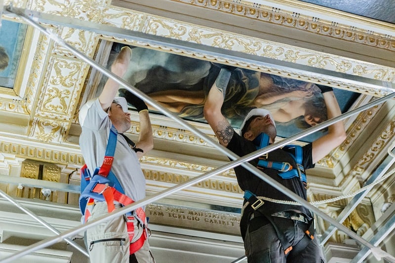 Art handlers remove Artemisia Gentileschi,Allegory of Inclination (1816) from the ceiling of the Casa Buonarroti, Florence. Photo by Olga Makarova, courtesy of the Casa Buonarroti, Florence.