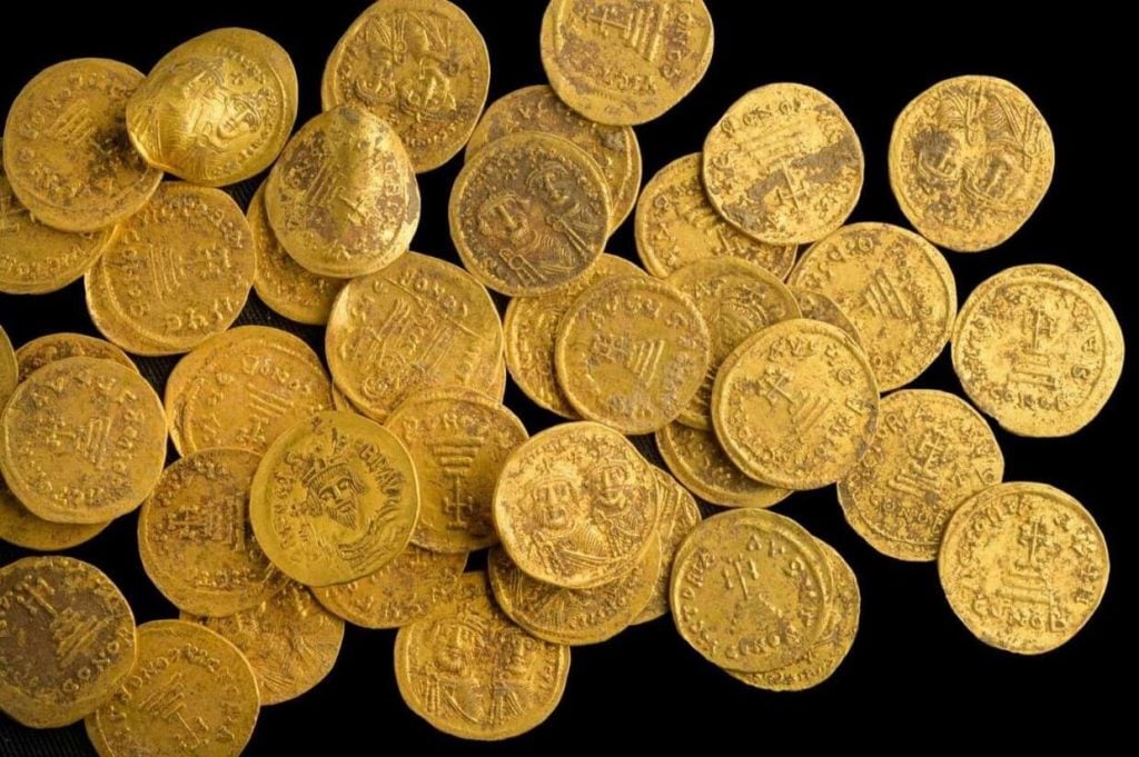 Archaeologists in Israel say 44 pure gold coins dating to the 7th century have been found hidden in a wall at a nature reserve. All photos: Israel Antiquities Authority Facebook. 