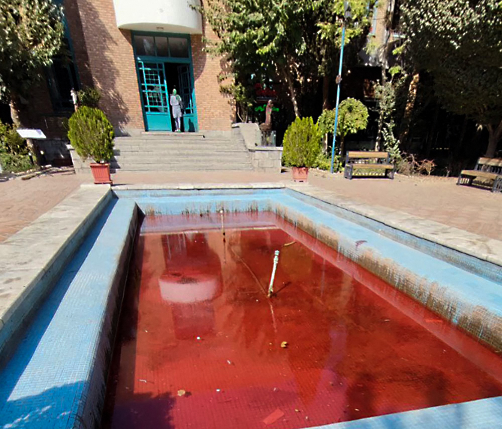A pool dyed red outside the Artists Forum at Honarmandan Park in the Iranian capital Tehran, reportedly in an anonymous artist protest responding to the death of Mahsa Amini in police custody. Photo by AFP via Getty Images.