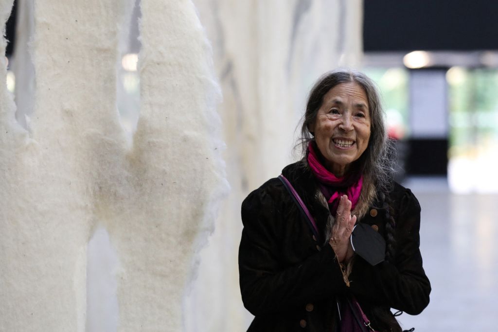 Chilean artist Cecilia Vicuna poses by her artwork of the latest Hyundai Commission for Tate Modern's Turbine Hall, in London, on October 10, 2022. Photo by Isabel Infantes/AFP via Getty Images.