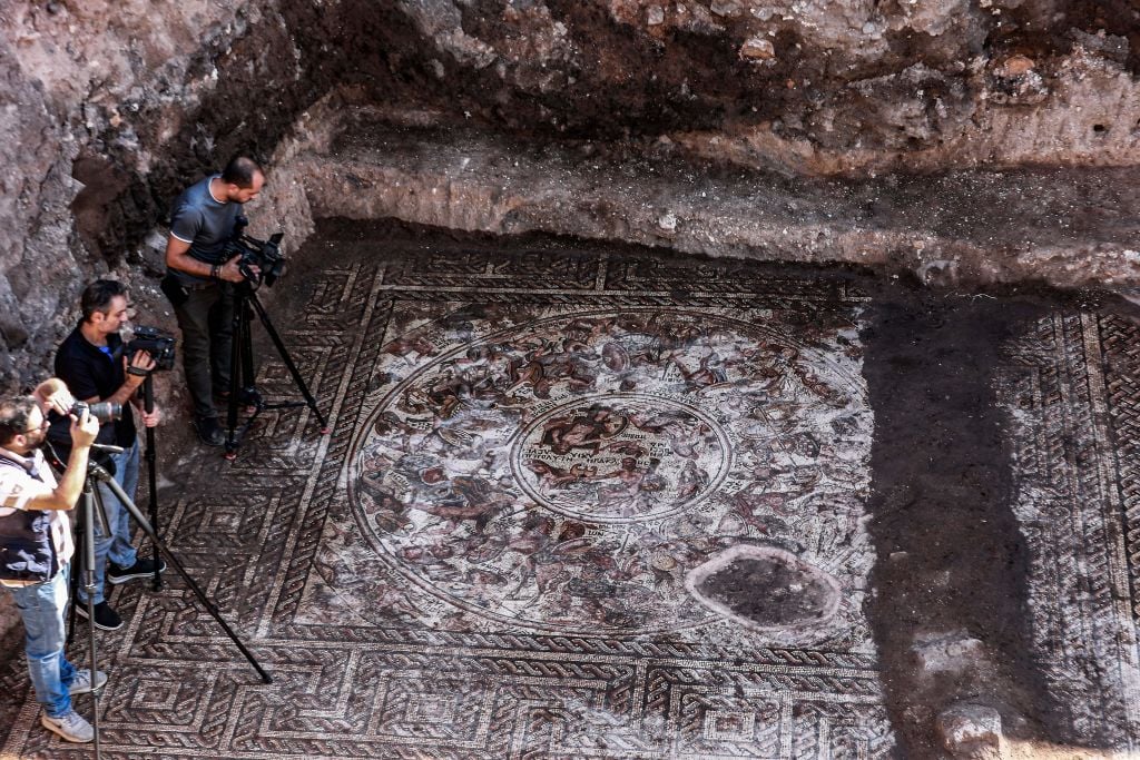 A mosaic floor dating to the Roman era being excavated in the city of al-Rastan in Syria's west-central province of Homs, after its discovery was announced by Syria's General Directorate of Antiquities (Photo by Louai Beshara / AFP) (Photo by LOUAI BESHARA/AFP via Getty Images)
