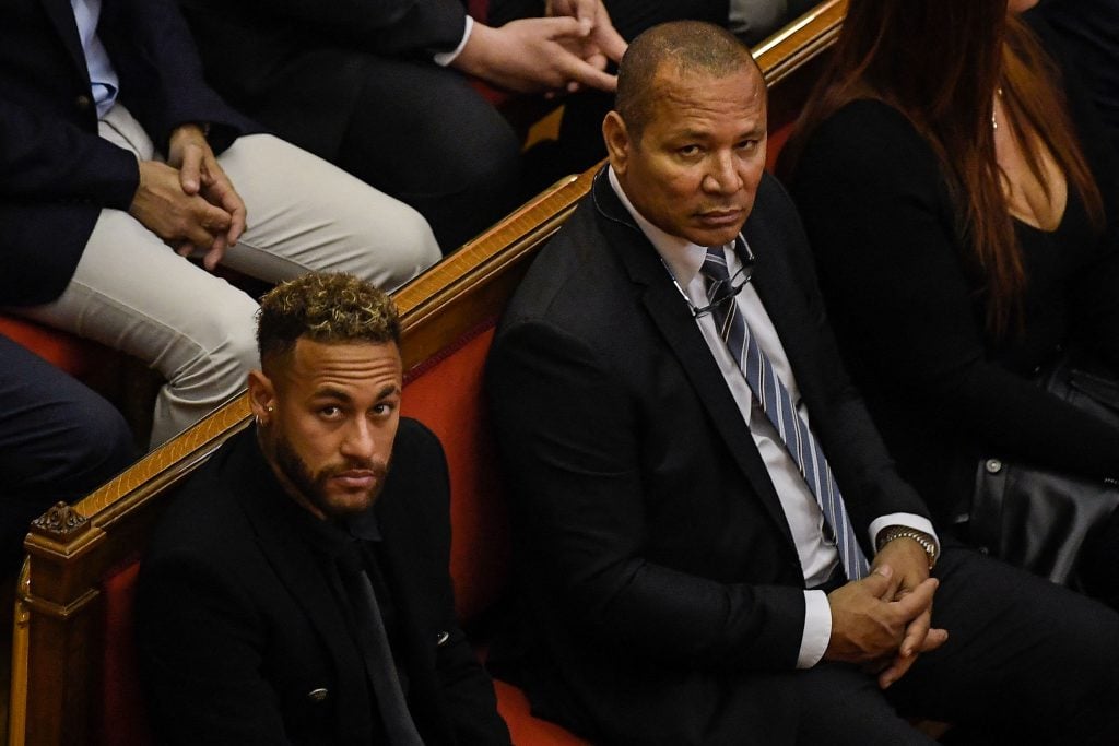 Paris Saint-Germain forward Neymar (L) and his father, former footballer Neymar Senior, look on during the opening audience at the courthouse in Barcelona on October 17, 2022, on the first day of their trial on charges related to the superstar's 2013 transfer to F.C. Barcelona. (Photo by Josep LAGO / AFP) (Photo by JOSEP LAGO/AFP via Getty Images)