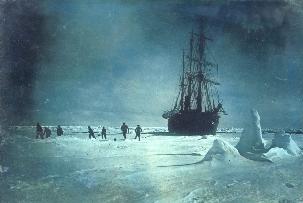 Soccer on the floe whilst waiting for the ice to break up around the <em>Endurance</eM>, 1915, during Ernest Shackleton's Imperial Trans-Antarctic Expedition. Photo by Frank Hurley/Scott Polar Research Institute, University of Cambridge/Getty Images.