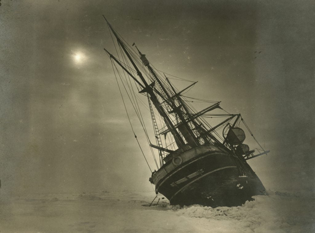 The <em>Endurance</em> leaning to one side during the Imperial Trans-Antarctic Expedition led by Ernest Shackleton. Photo by Frank Hurley/Scott Polar Research Institute, University of Cambridge/Getty Images.