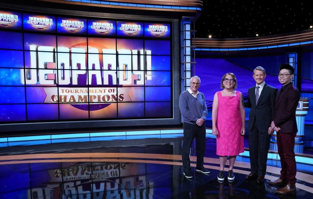 Jeopardy Tournament of Champions finalists Sam Buttry, Amy Schneider, and Andrew He pose with host (and the show's winningest contestant of all time) Ken Jennings (third from left). Photo by Tyler Golden/Sony Pictures Television ©2022 Sony Pictures Television.