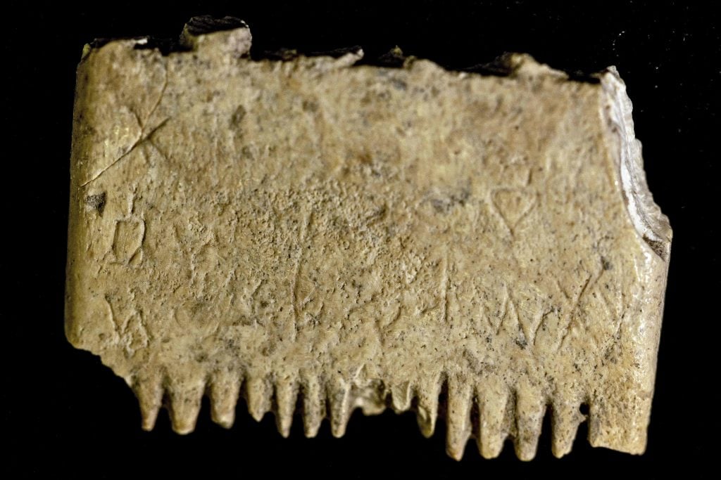 A picture taken at the conservation laboratory of the Hebrew University in Jerusalem on November 8, 2022, shows an ivory comb with a rare inscription that sheds new light on the use of Canaanite language some 3,700 years ago. Archaeologists discovered the artifact in southern Israel at the Tel Lachish site. Experts just noticed that 17 letters inscribed on the comb say 
