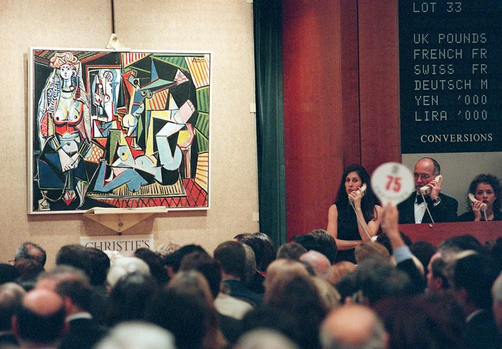 A bid comes in for Pablo Picasso's painting, Les femmes d'Alger 10 November in New York at Christie's auction house. The painting sold for 31.9 million USD and was one of 58 pieces of 20th century art offered for sale from the collection of Victor and Sally Ganz. Photo by Stan Honda/AFP via Getty Images.