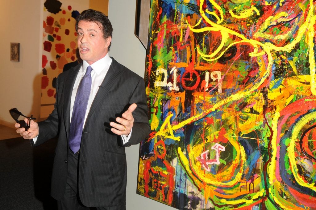 Sylvester Stallone with his artwork on December 2, 2009 in Miami Beach, Florida. (Photo by Clint Spaulding/Patrick McMullan via Getty Images)