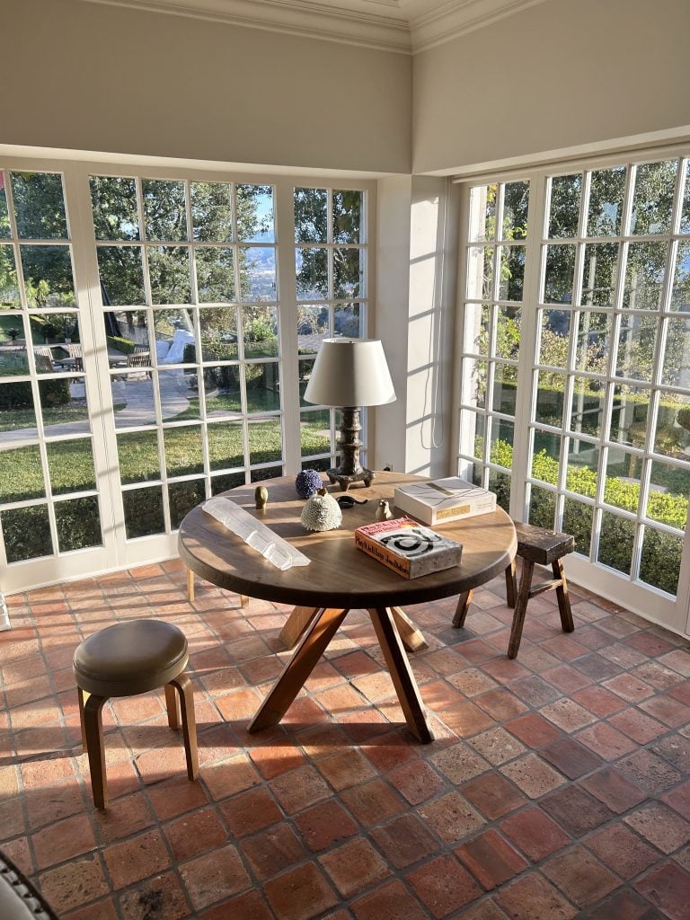 Sarah Harrelson's sunroom is home to a Pierre Chapo table, a Seth Bogart Joan Didion ceramic, and Haas Brothers ceramics. Photo courtesy of Sarah Harrelson. 