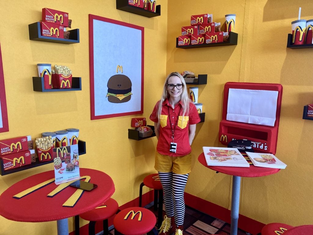 Lucy Sparrow with her Mcdonald’s installation at Scope Miami Beach. Photo by Sarah Cascone. 