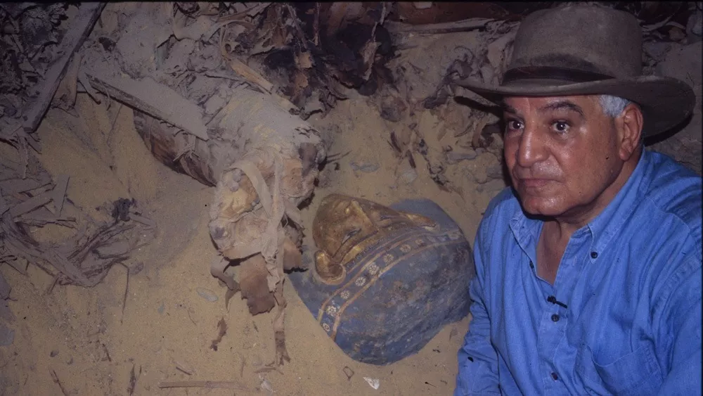Egyptologist Zahi Hawass with one the newly discovered mummies from excavations at Saqqara. Photo courtesy of Zahi Hawass.