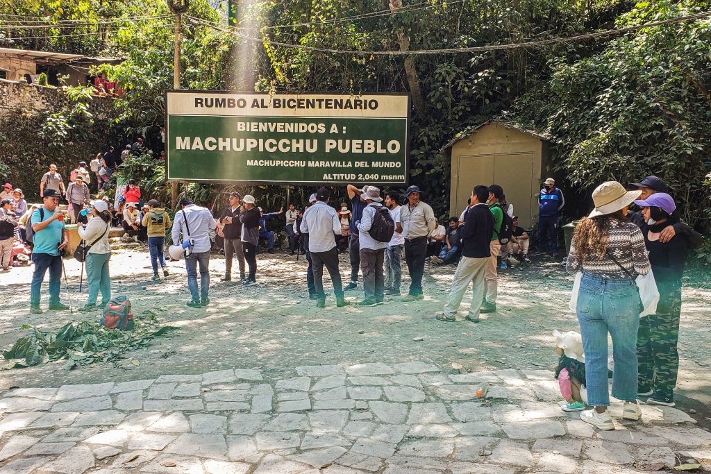 Tourists are seen while a protest is being held in Aguas Calientes, in the foothills of Machu Picchu, the famous Inca ruins, in the Peruvian Andes, on August 24, 2022, causing rail service to the town to be suspended. Photo by Jesus Tapia/AFP via Getty Images.