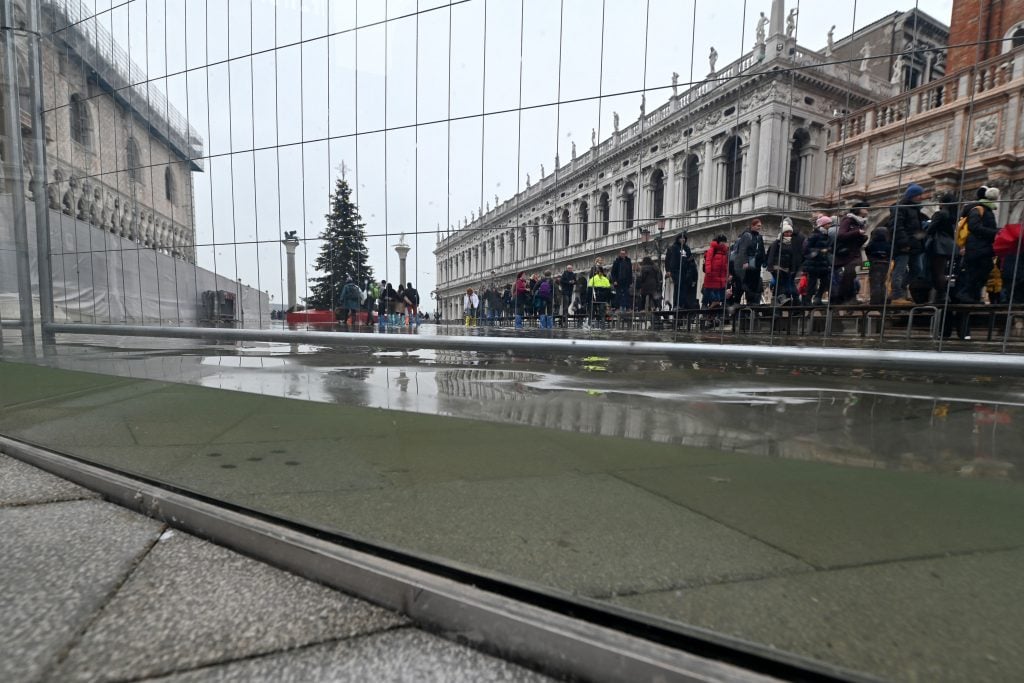 St. Mark's Basilica is now protected by transparent glass barriers that keep out the floodwaters of Acqua Alta events, as seen in this photo from December 10, 2022. The high tide was too low to operate the MOSE Experimental Electromechanical Module that protects the city of Venice from floods. Photo by Andrea Pattaro for AFP via Getty Images.
