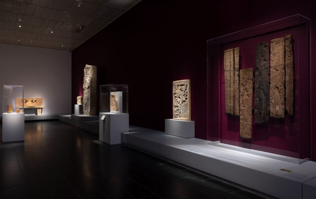 Installation view of "Lives of the Gods: Divinity In Maya Art" the Metropolitan Museum of Art, New York. The Maya throne can be seen on the far wall. Photo by Richard Lee, courtesy of the Metropolitan Museum of Art, New York.