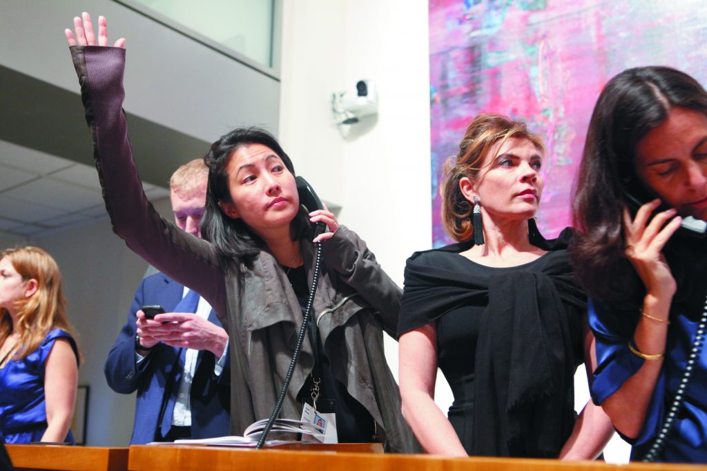 Patti Wong photographed bidding in 2011. Courtesy Sotheby's. 